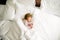 Cute little toddler girl sleeping in big bed of parents. Adorable baby child dreaming in hotel bed on family vacations