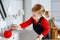 Cute little toddler girl washing hands with soap and water in bathroom. Adorable child learning cleaning body parts