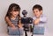 Cute little video bloggers recording video on white background.