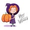 Cute little witch holding a big pumpkin and smiling
