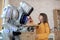 Cute long-haired girl feeding the house robot