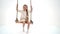 Cute long haired girl sitting on rope swing