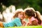 Cute love. Little girl kissing boy outdoors in park. Children relationships.