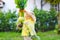 Cute lovely toddler girl with kohlrabi in vegetable garden. Happy gorgeous baby child having fun with first harvest of