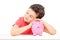 Cute male child sleeping on a piggybank