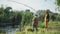 cute male kids in hats have fun fishing in the river using fishing rods while out of town summer vacation