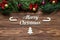 Cute Merry Christmas theme with cardboard candy canes and fir tree exposition on the wooden background