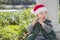 Cute Mixed Race Boy in Santa Hat eating Candy Cane