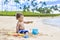 Cute mixed race little boy playing in the sand on a tropical beach vacation