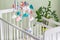 Cute mobile with clouds, stars and moon hanging on a crib in a children's room