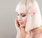 Cute Model Woman with Healthy Skin and Pink Orchid Flower. Facial Treatment and Cosmetology Concept