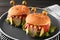 Cute monster burgers on table, closeup. Halloween party food