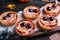 Cute monster tartlets served on wooden table, closeup. Halloween party food