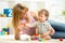 Cute mother and child boy play together indoor at