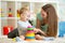 Cute mother and child boy play together indoor at