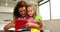 Cute mother and daughter doing arts and crafts at kitchen table