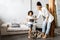 A cute mother and daughter talk and look at the tablet while standing in the living room