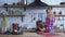 Cute mother in plaid shirt with long blond hair cooking breakfast and small naughty girl bite one cookie