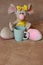 Cute mouse toy with tea cup sitting on sofa. Soft animal toy. Good morning concept. Childhood background. Funny soft mouse toy.