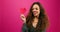 Cute multi-ethnic woman poses with paper hearts, symbol of love studio Valentine