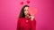 Cute multi-ethnic woman poses with paper hearts, symbol of love studio Valentine