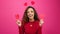 Cute multi-ethnic woman poses with paper hearts, symbol of love studio Valentine