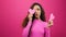 Cute multi-ethnic woman poses with paper hearts, symbol of love studio Valentine