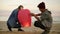 Cute multiethnic couple holding red paper lantern before launching. Attractive woman with her african boyfriend holding