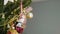Cute New Year snowman happily bouncing on Christmas tree, winter holiday toy
