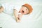 Cute newborn baby beanie lying on the bed