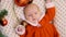 Cute newborn baby girl lies among Christmas toys