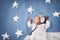 Cute newborn baby girl lying in the bed. 2 month old child in owl hat sleeping on blue blanket