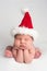 Cute Newborn Baby Girl Wearing a Santa Hat