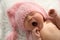 Cute newborn baby in hat yawning on fuzzy blanket, closeup