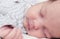 Cute newborn baby sleeping, face closeup