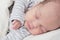 Cute newborn baby sleeping, one month old, face closeup