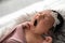 Cute newborn baby yawning on fuzzy blanket, closeup