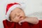 Cute newborn infant wearing santa hat for christmas