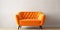 Cute orange velvet loveseat sofa or snuggle chair in empty room. Interior design of modern minimalist living room