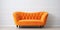 Cute orange velvet loveseat sofa or snuggle chair in empty room. Interior design of modern minimalist living room