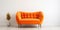 Cute orange velvet loveseat sofa or snuggle chair in empty room. Interior design of modern minimalist living room