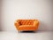 Cute orange velvet loveseat sofa or snuggle chair in empty room. Interior design of modern minimalist living room