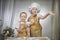 Cute oriental family with small brother and sister cooking in kitchen on Ramadan, Kurban-Bairam, Eid al-Adha. Funny