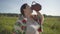 Cute overweight woman enjoys drinking fresh milk from the earthen jug on the green summer field. Beautiful landscape