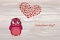Cute owlet dreams of love. Owl looks at the heart top. Greeting