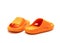 Cute pair of orange pillow slide sandals for toddler non-slip foam slippers isolated on white