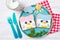 Cute penguin toasts with spread on a plate, food for kids ideas, top view