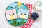 Cute penguin toasts with spread on a plate, food for kids ideas, top view