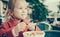 Cute pensive girl eating fries