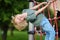 Cute perky preschooler boy having fun on outdoor playground. Spring or summer or autumn active sport leisure for kids. Outdoor